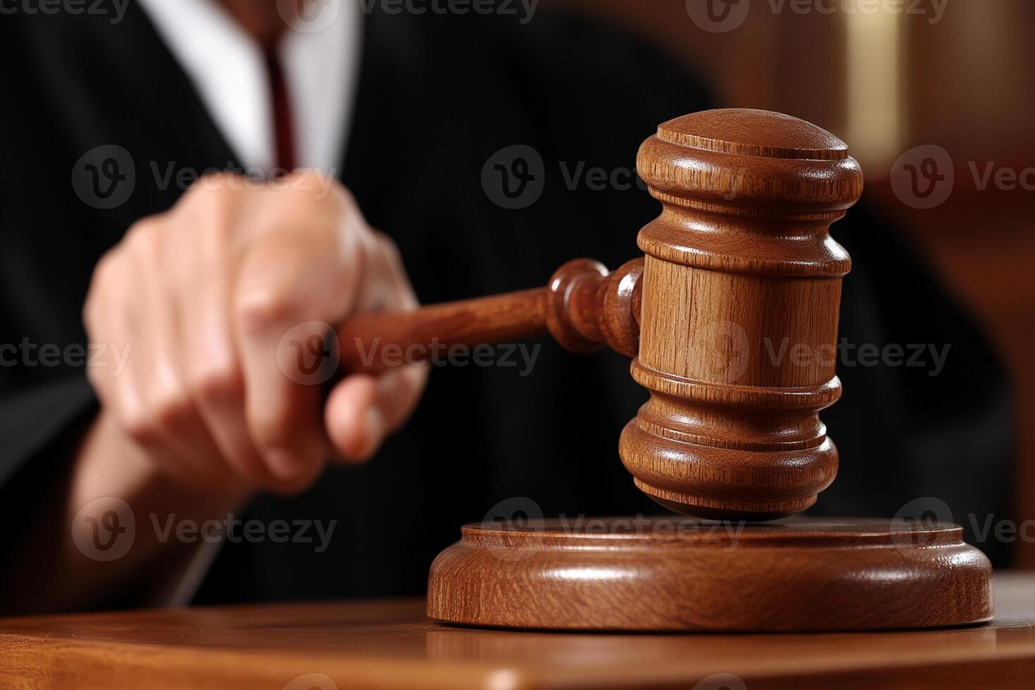A judge's gavel on a wooden table photo