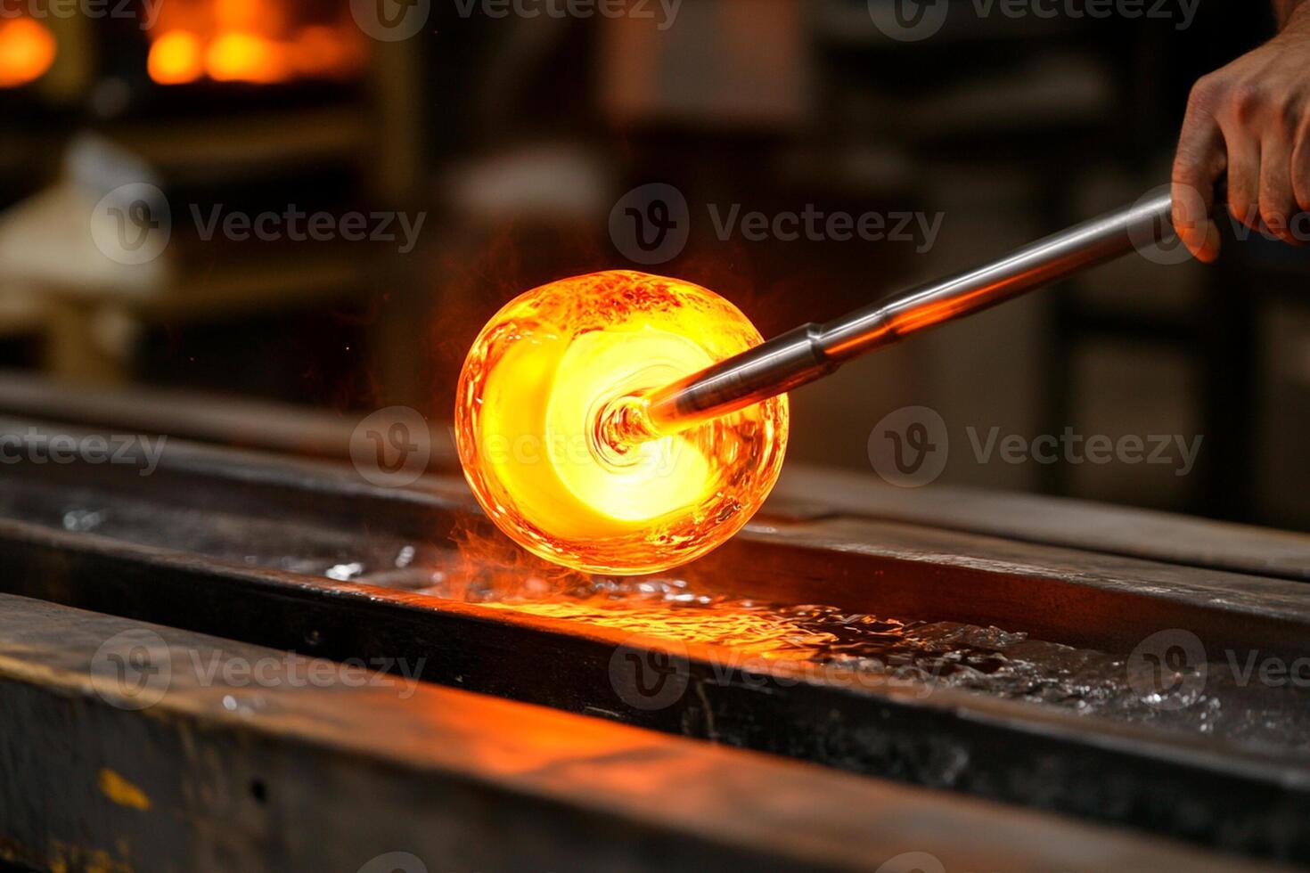 A person is blowing glass with a hammer photo