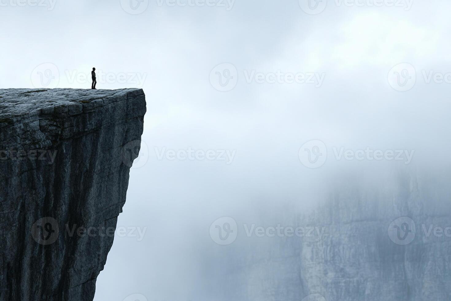 A man standing on the edge of a cliff photo