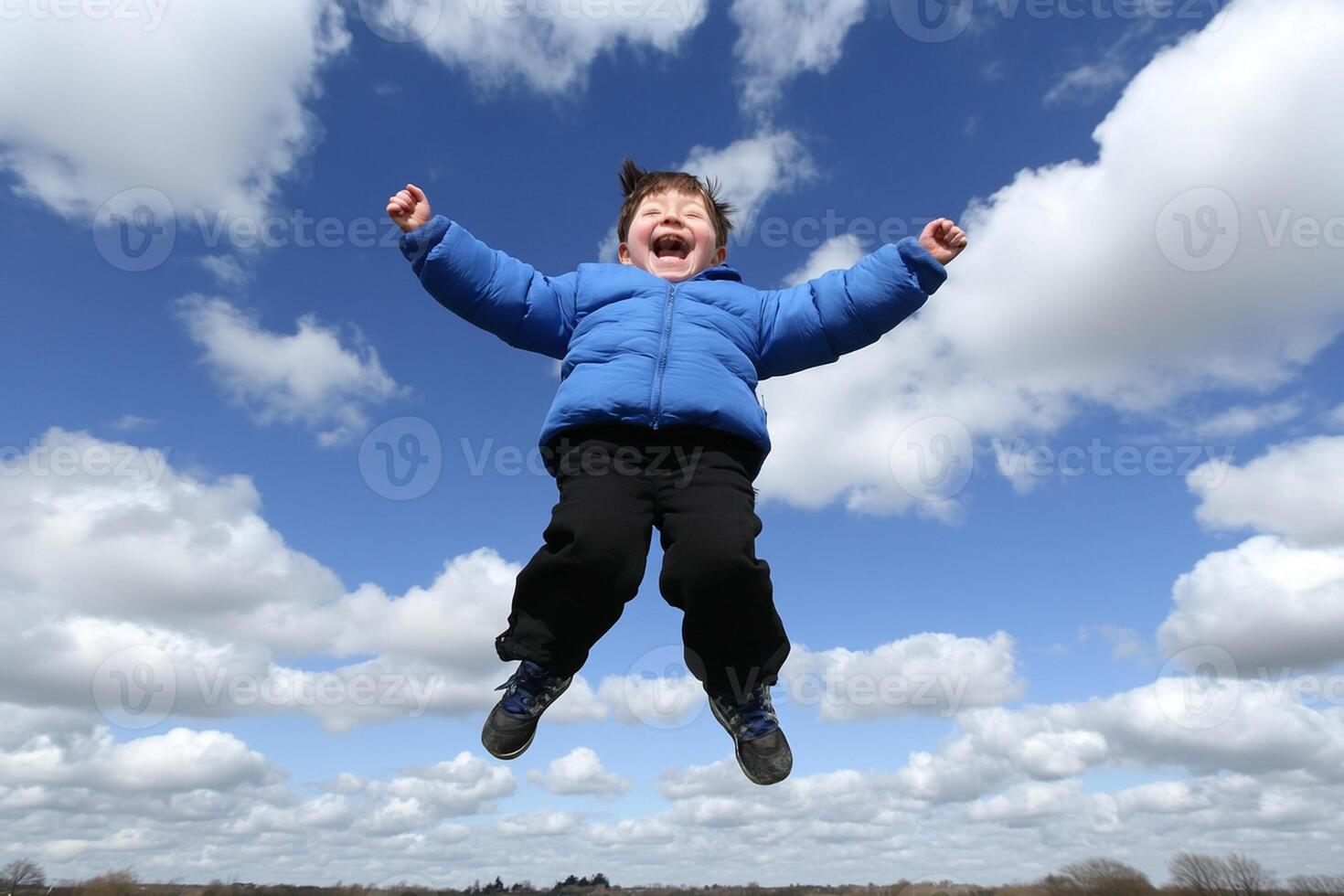 A young boy is jumping in the air photo