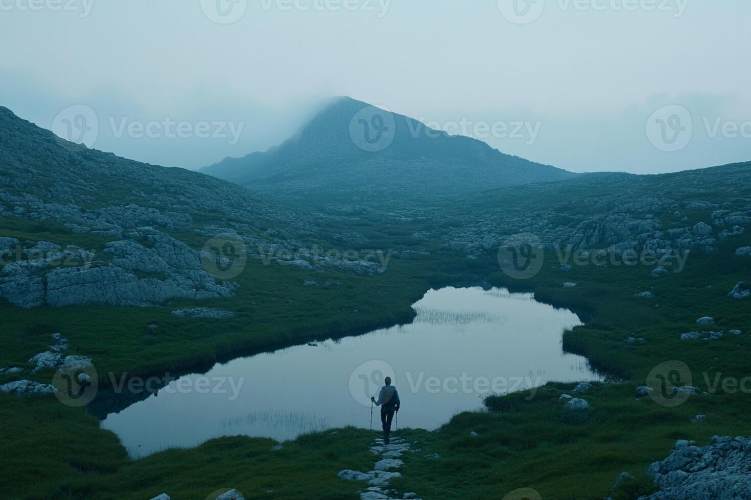 A person walking along a path in the mountains photo