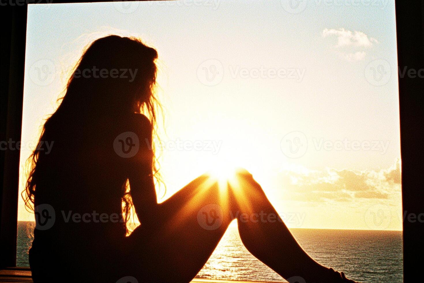 A woman sitting on a window sill photo