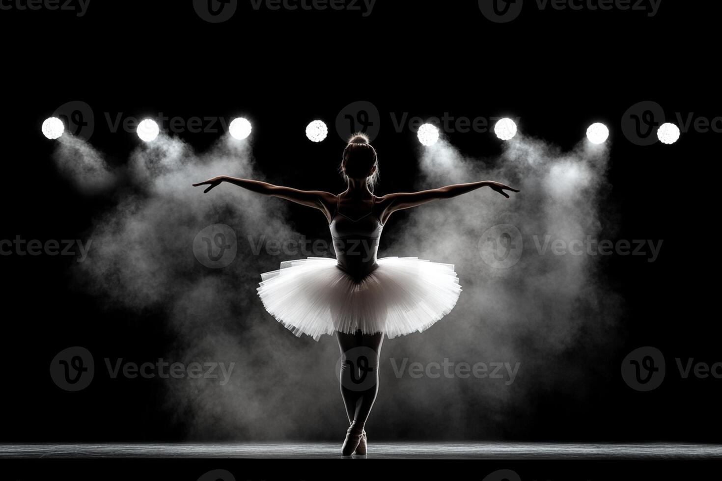 A ballerina in a white tutu and skirt is standing in front of a spotlight photo