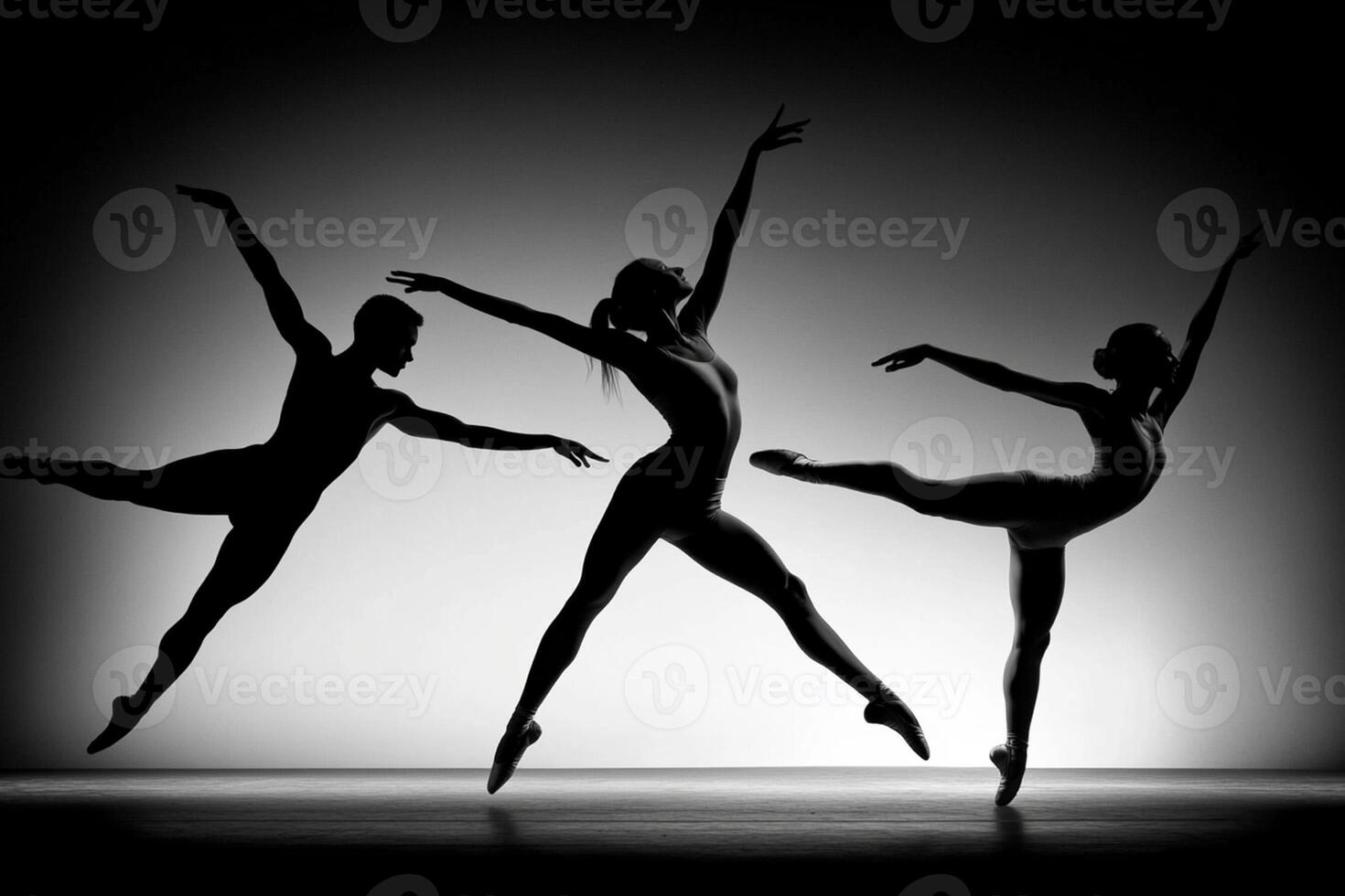 Three dancers in silhouette on a black background photo