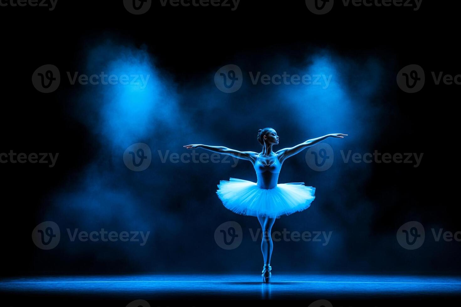 A ballerina in a blue dress is standing in the spotlight photo