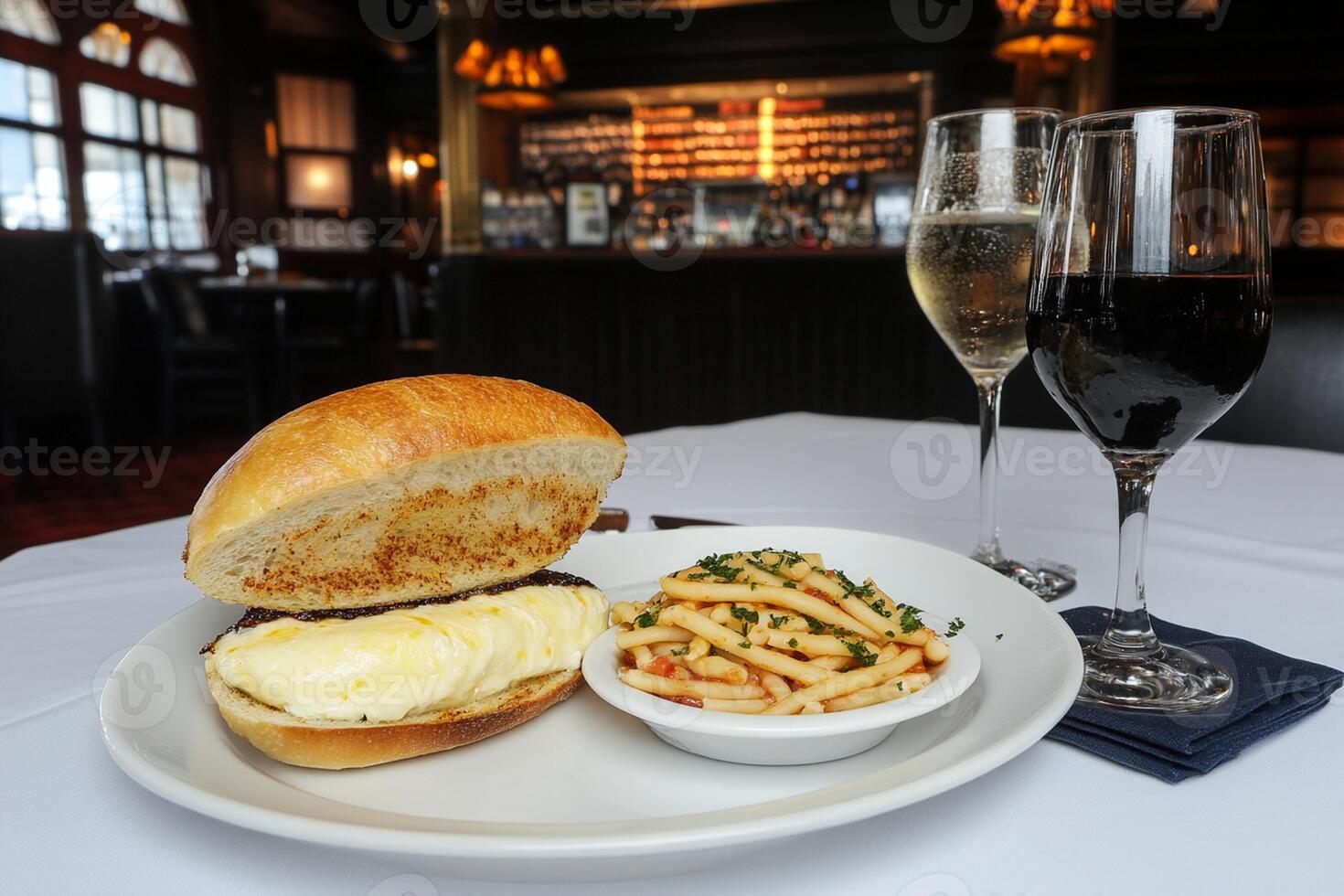 A plate with a sandwich and a glass of wine photo