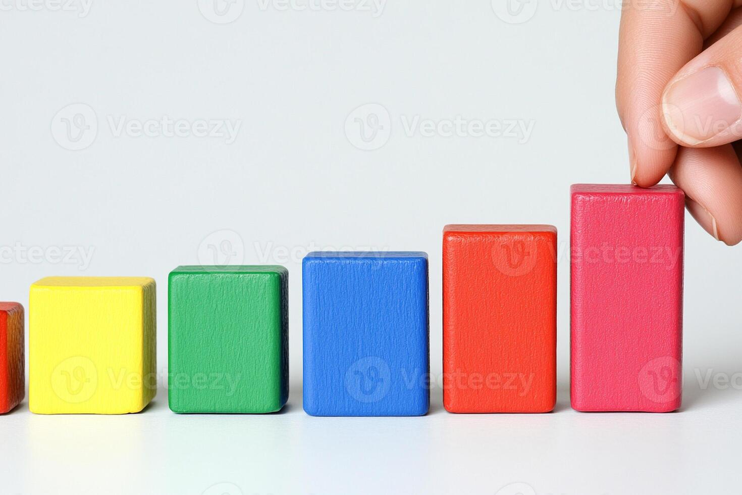 A person is holding a wooden block with colorful blocks photo
