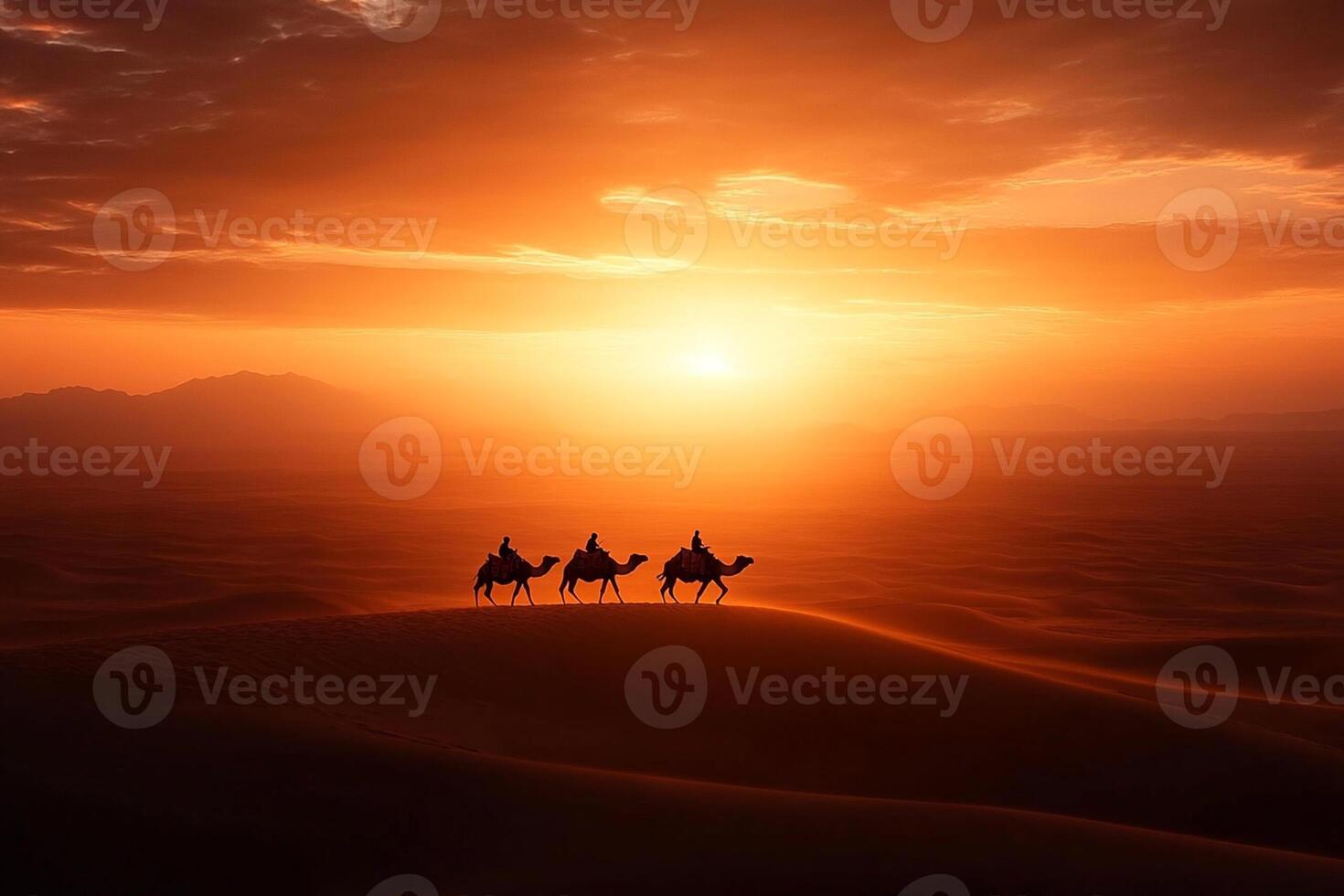 Three people riding camels in the desert at sunset photo