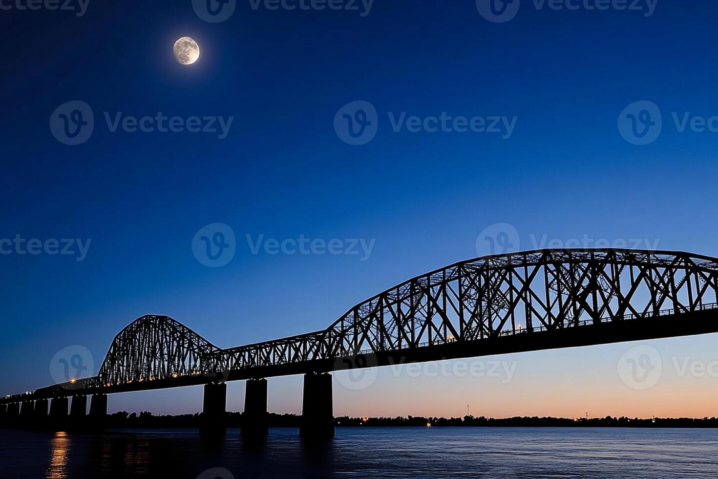 The moon rises over the mississippi river bridge in the evening photo