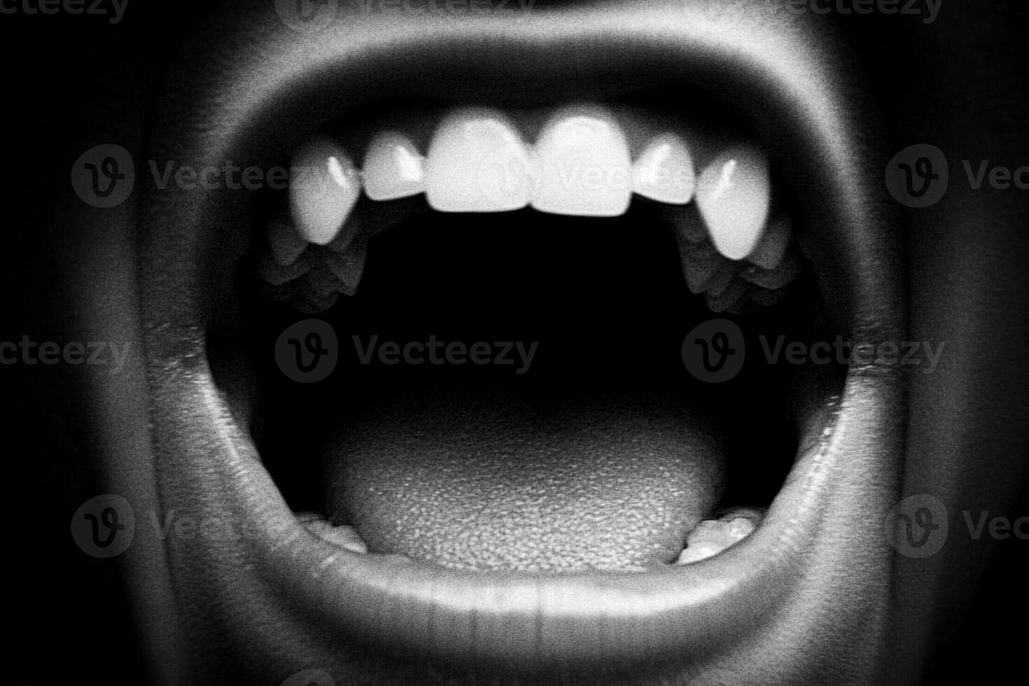 A close up of a person's mouth with teeth open photo