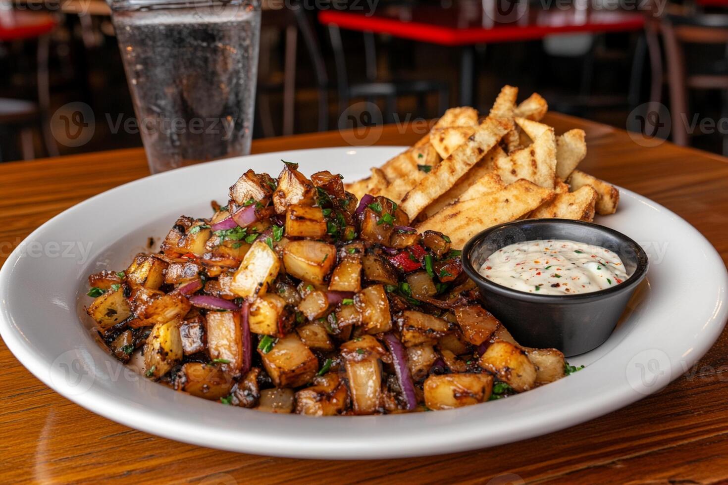 A plate of food with fries and dip on a table photo