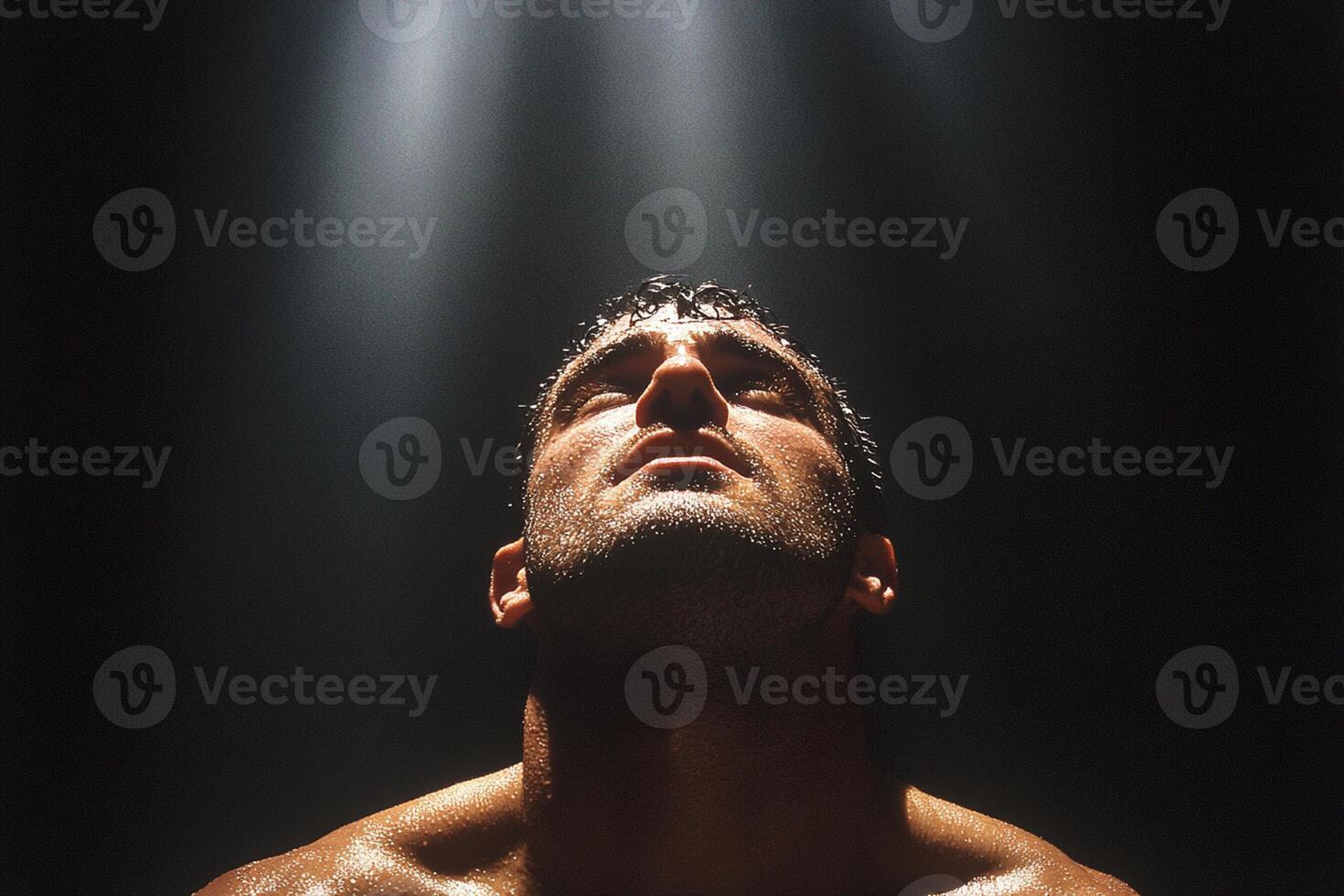A man with no shirt on in the dark photo