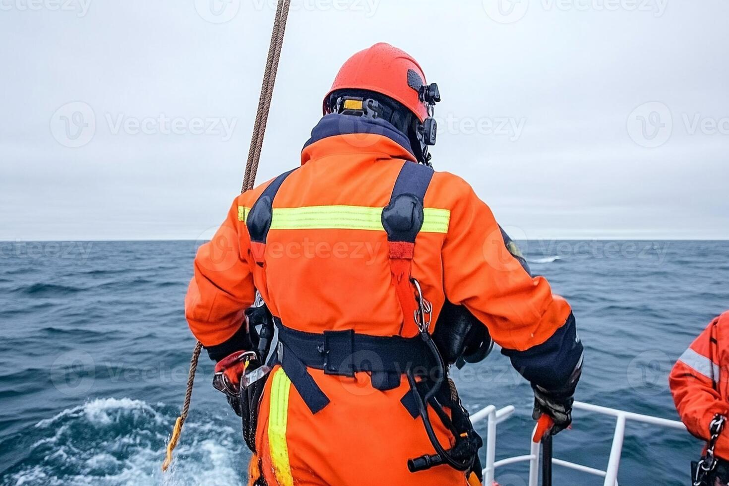 Two men in orange life jackets on a boat photo