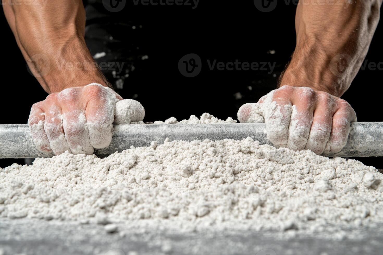 A man is rolling a ball of white powder photo