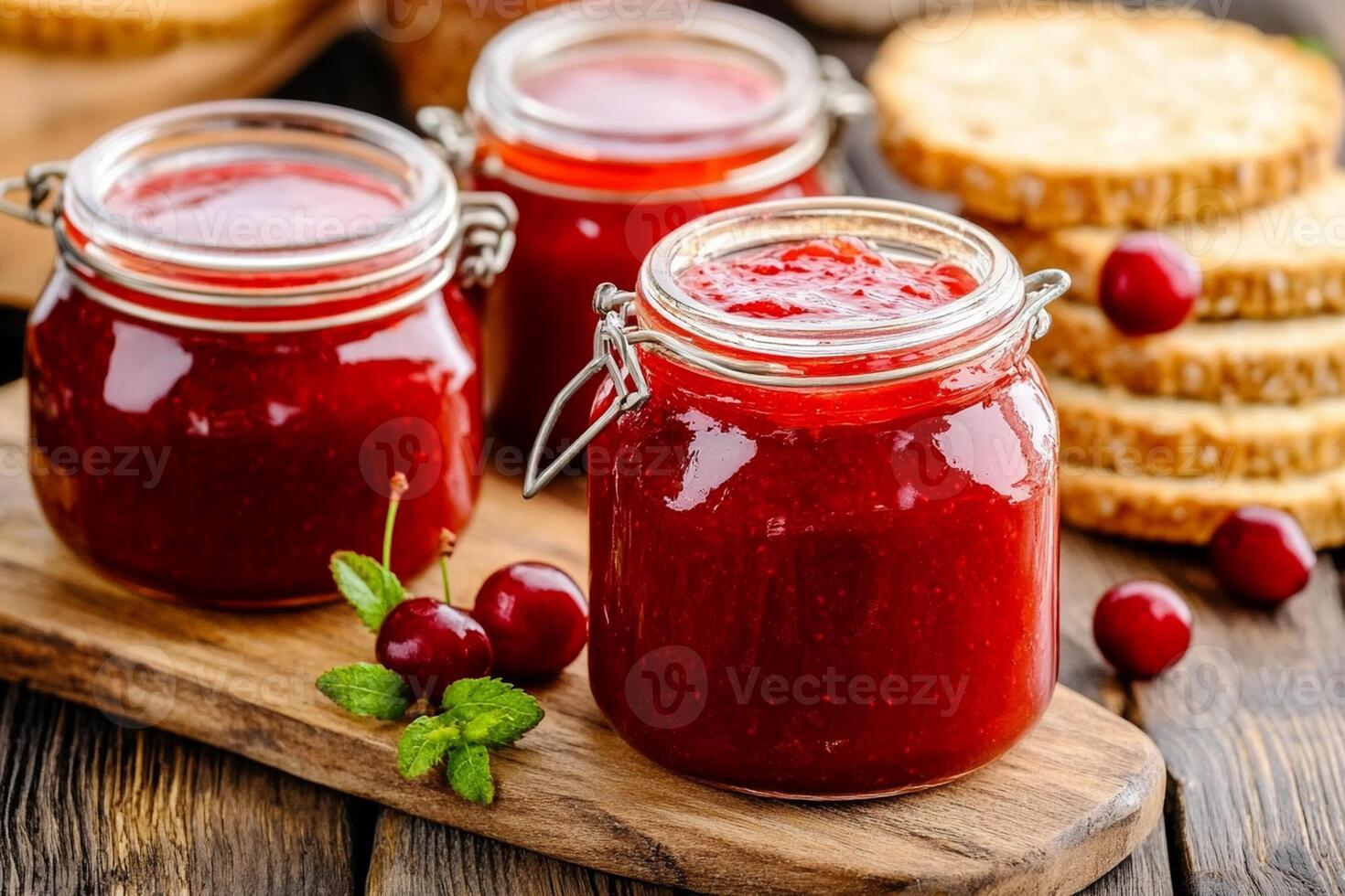 Cherry jam in jars on a wooden table photo