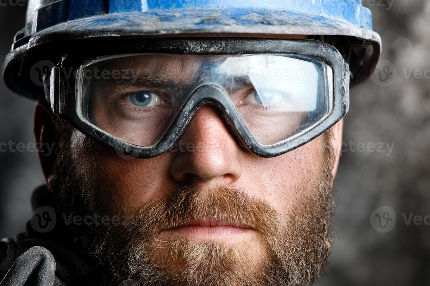 A man with a beard and goggles in a hard hat photo