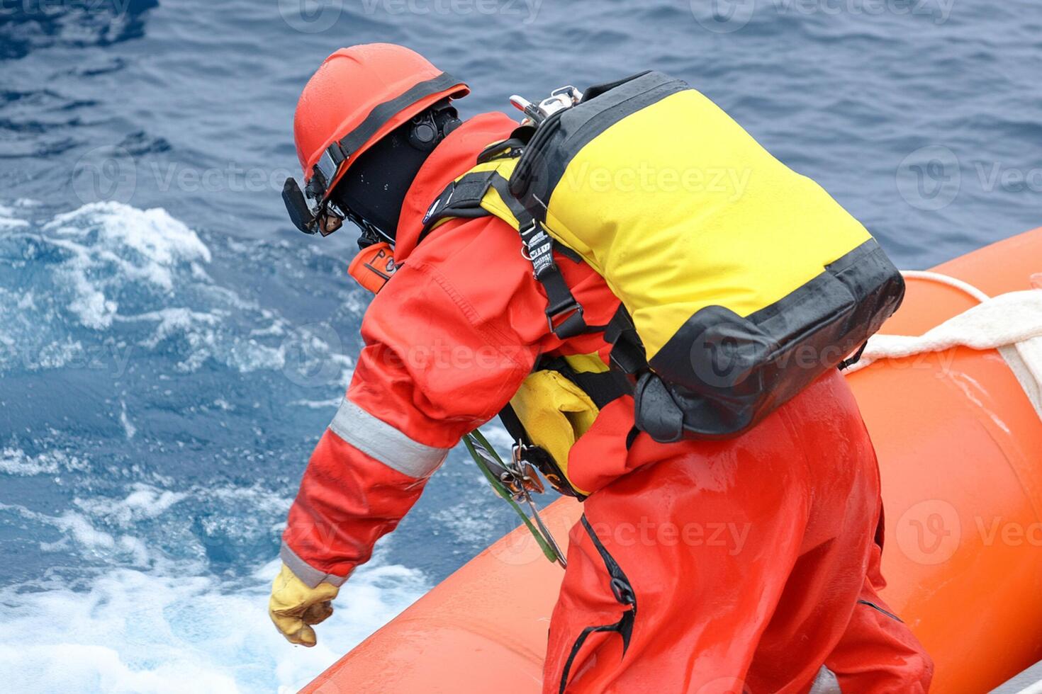 A man in an orange life jacket on a boat photo