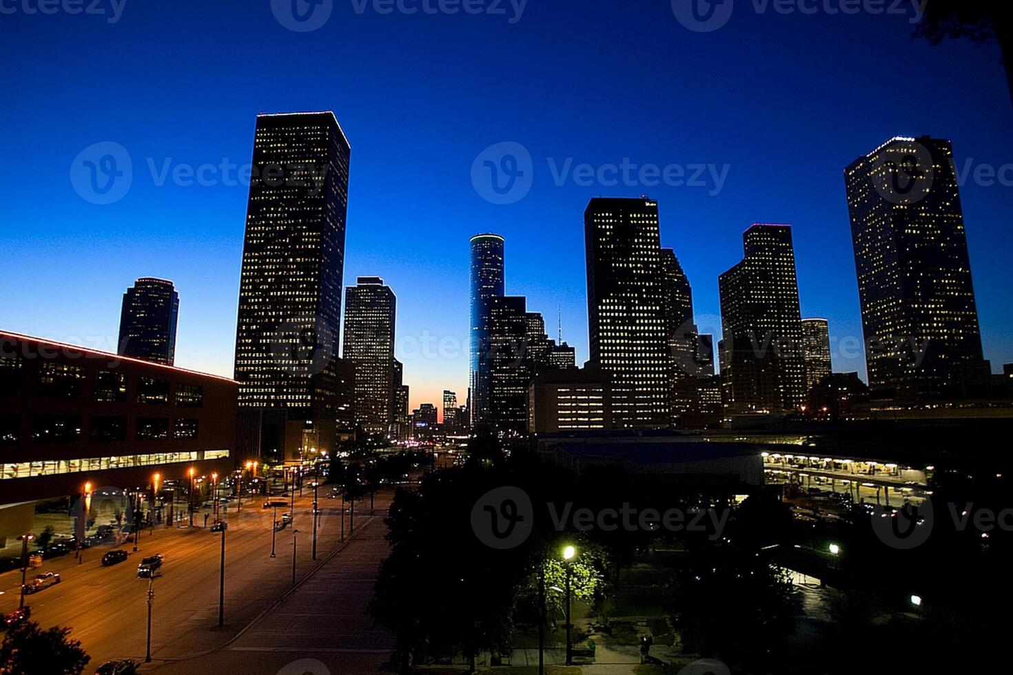 A city skyline at dusk with a few buildings in the background photo