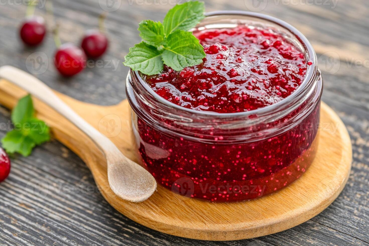 Cherry jam in a glass jar on a wooden table photo