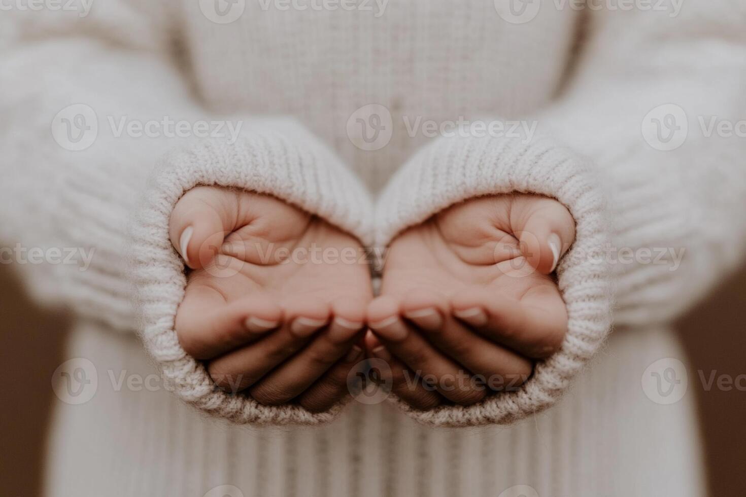 A person in a sweater is holding their hands out photo
