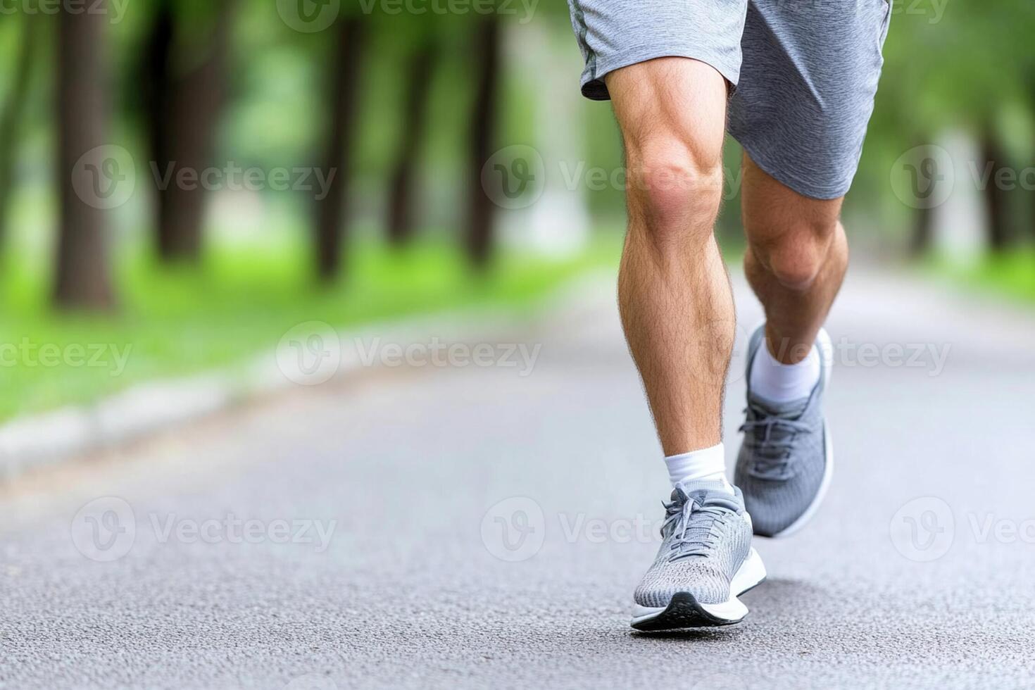 A man is running on a road in the park photo
