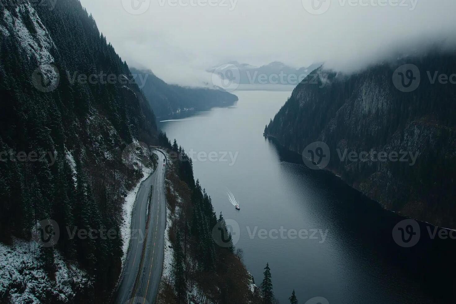 A boat is traveling down a river in the middle of a mountain photo