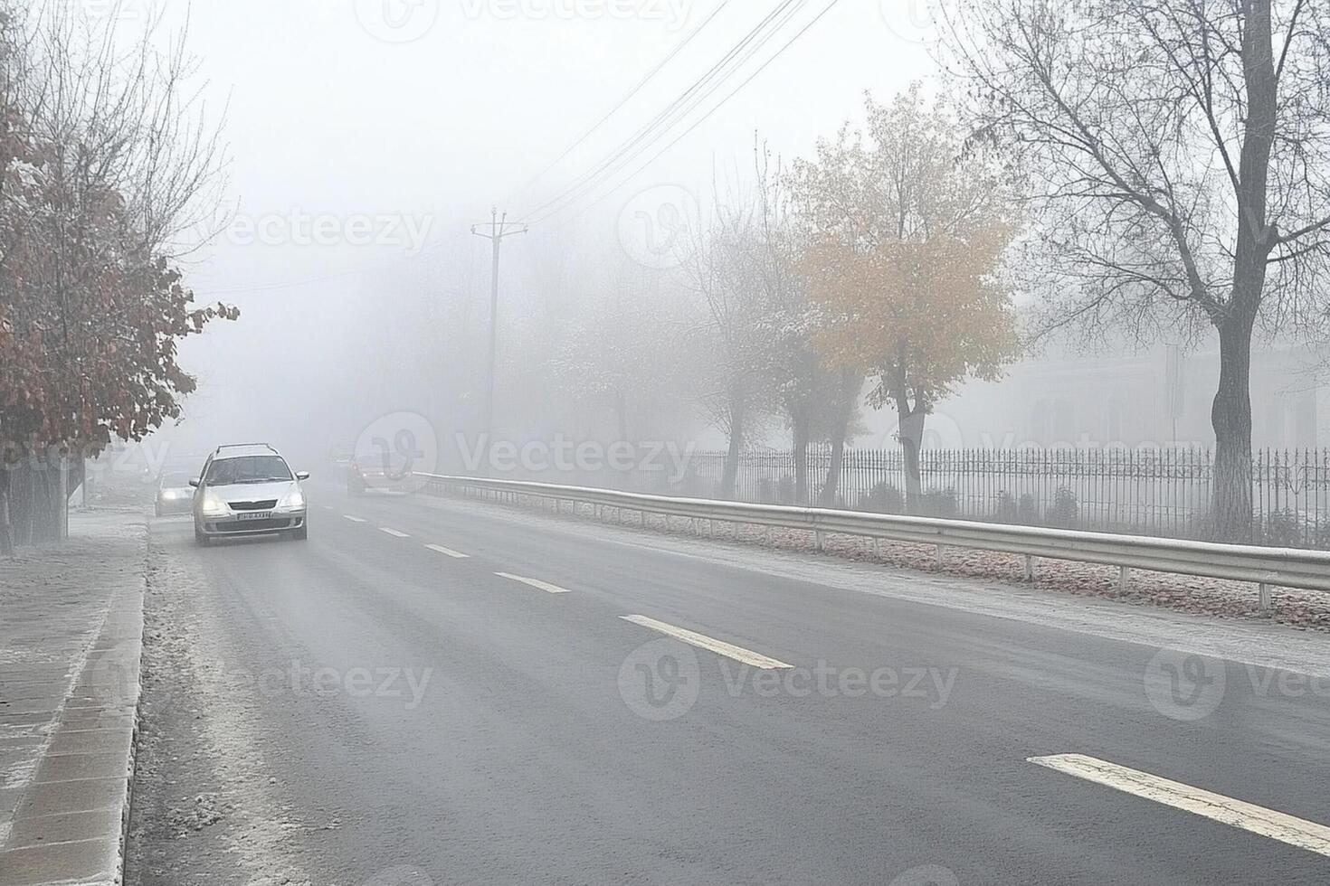 A car driving down a foggy road in the city photo
