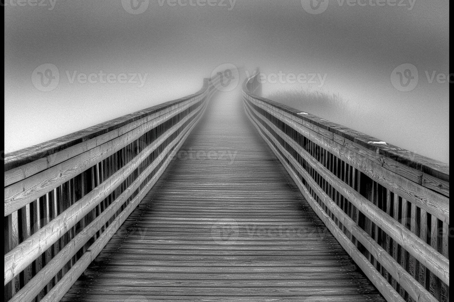 A black and white photo of a bridge in the fog