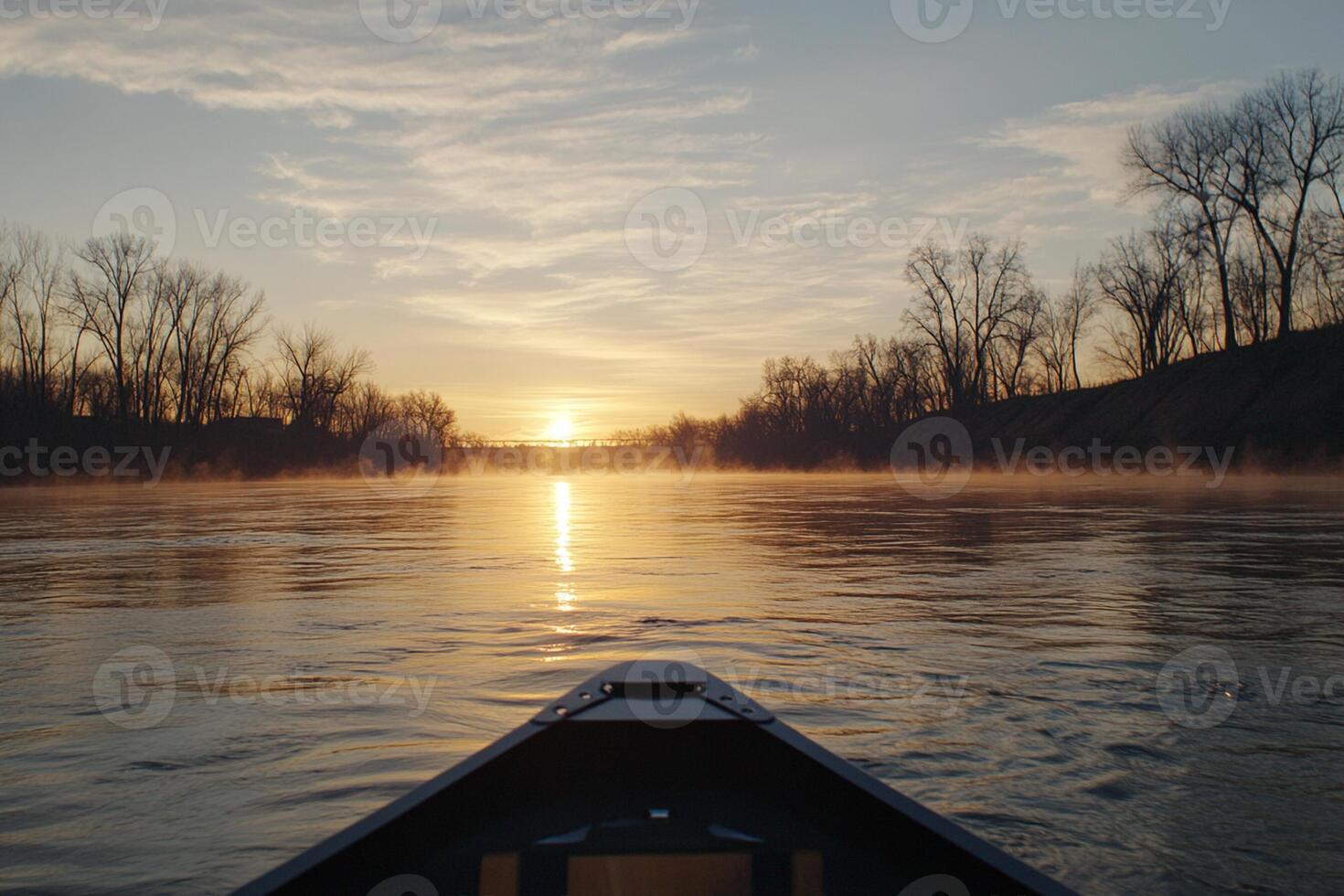 A canoe is on the water at sunset photo