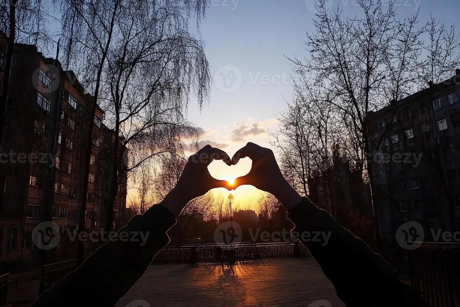 A person making a heart shape with their hands photo