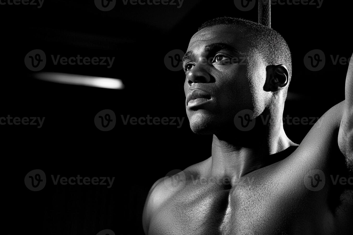 A man with no shirt on is holding a rope photo