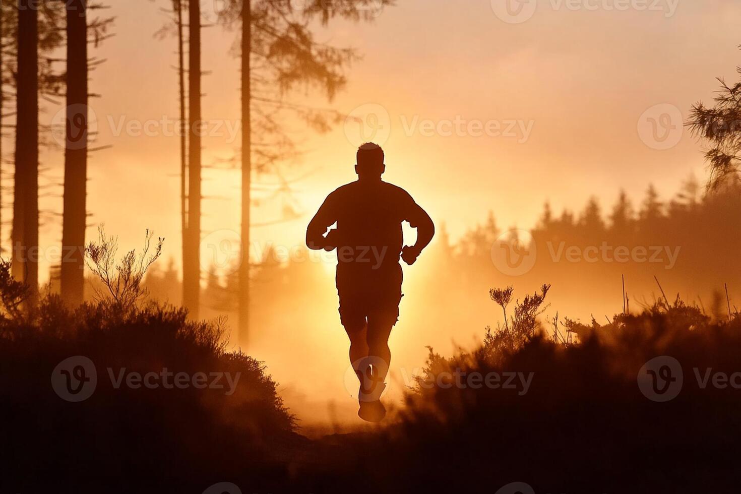 A man running in the woods at sunset photo