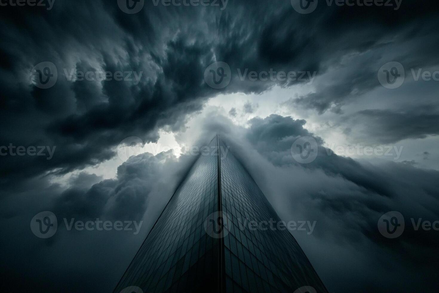 A skyscraper is seen in the sky with dark clouds photo