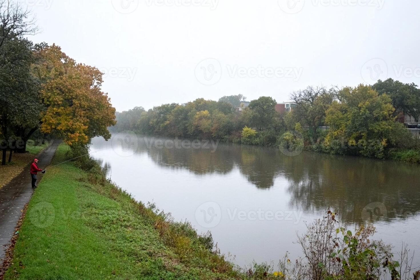 A person walking along the river in the fog photo