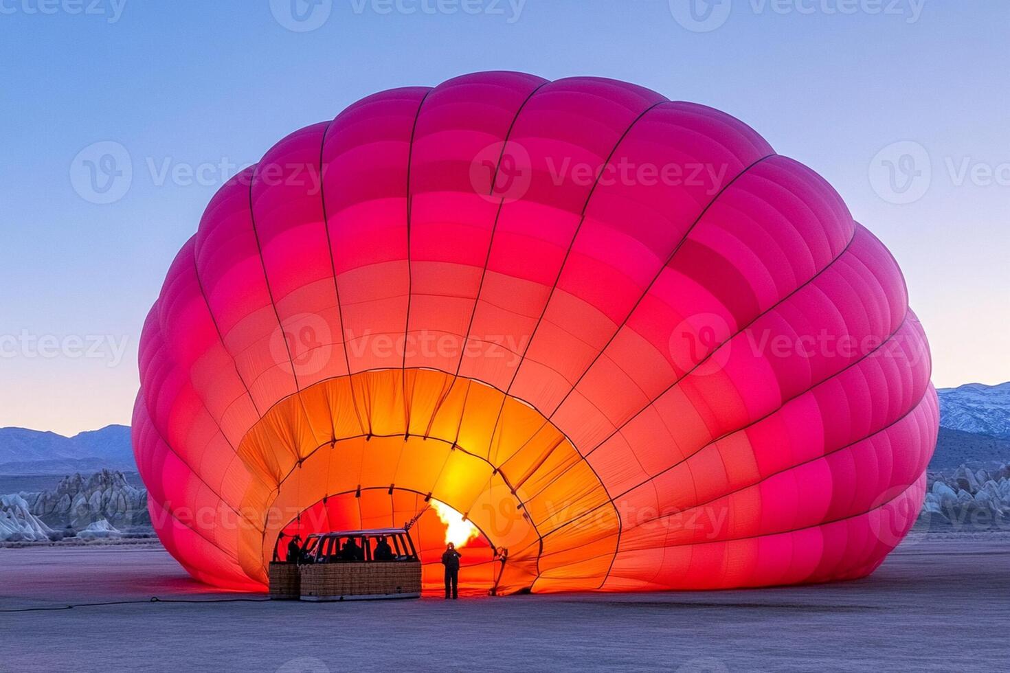 A large hot air balloon is lit up in the desert photo
