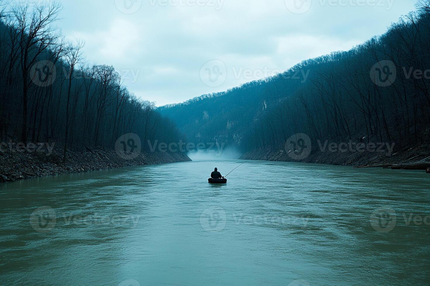 A man is in a boat on a river photo