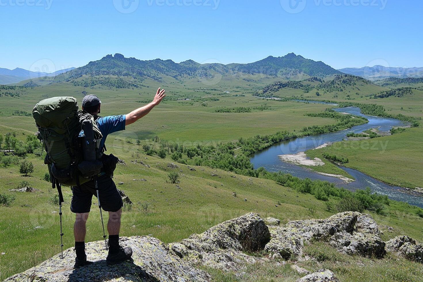A man with a backpack on a mountain top photo