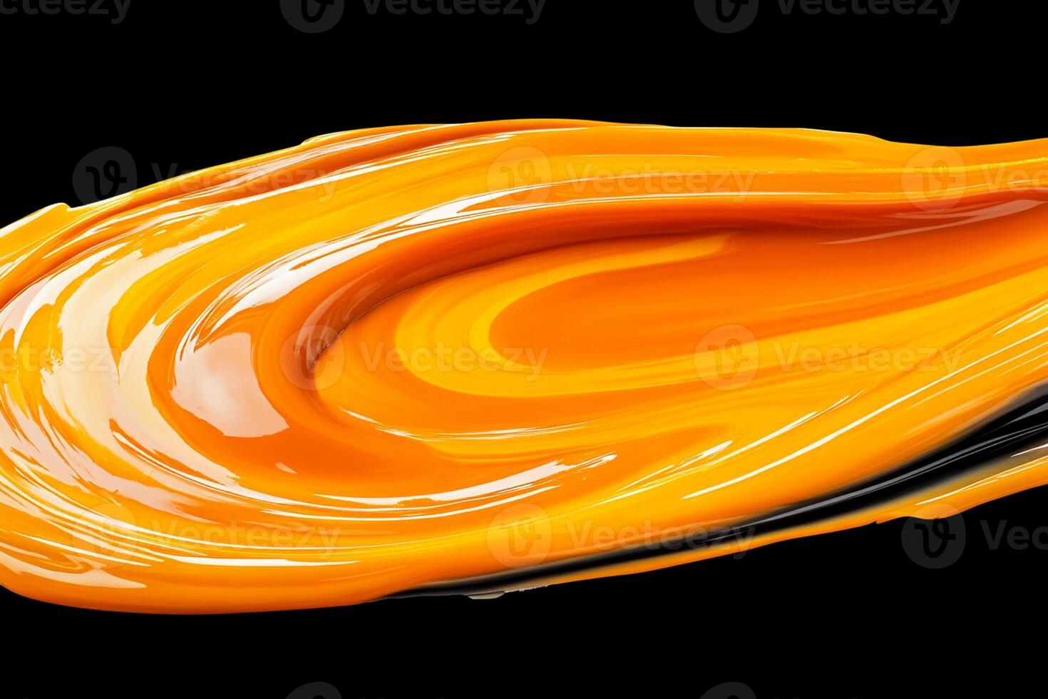 Orange liquid flowing over a black background photo