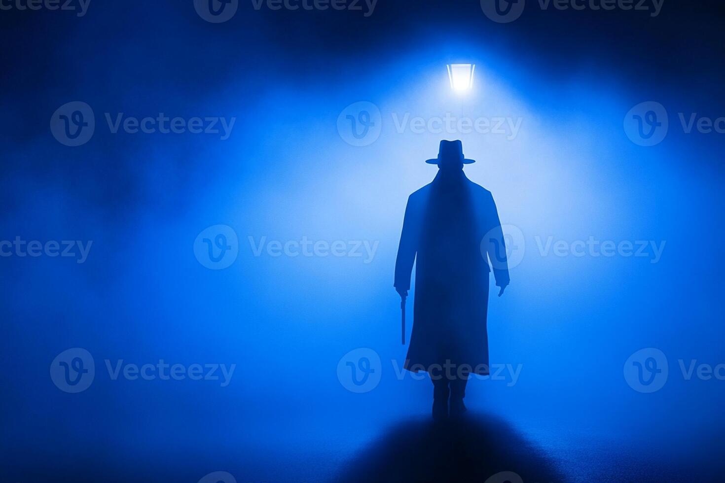 A man in a hat and coat is walking through a foggy room photo