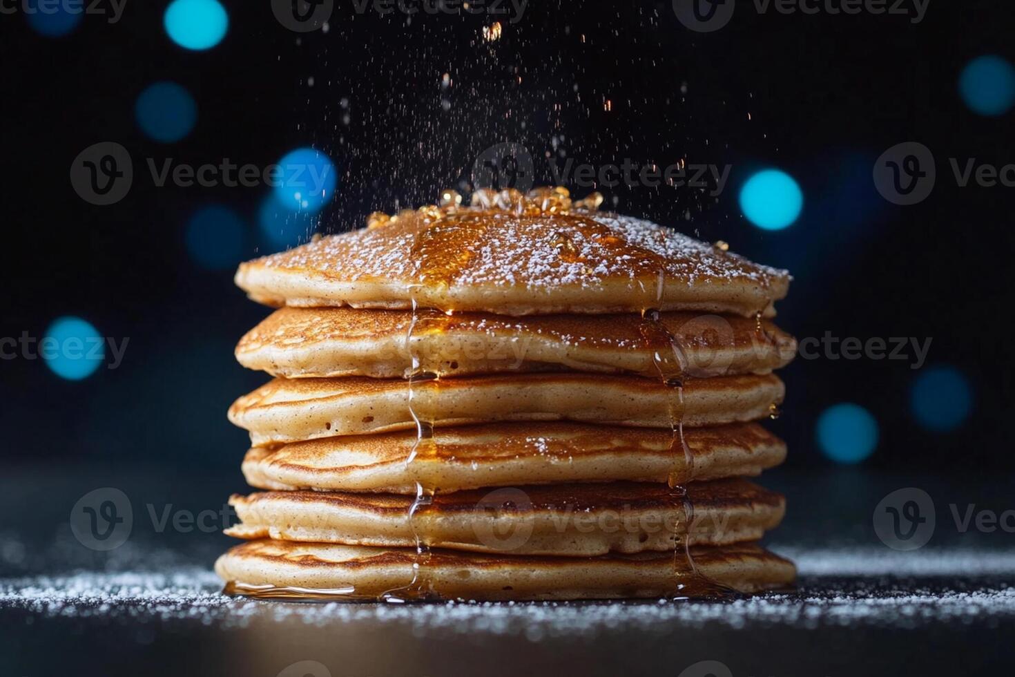 Stack of pancakes with syrup and sugar on a dark background photo