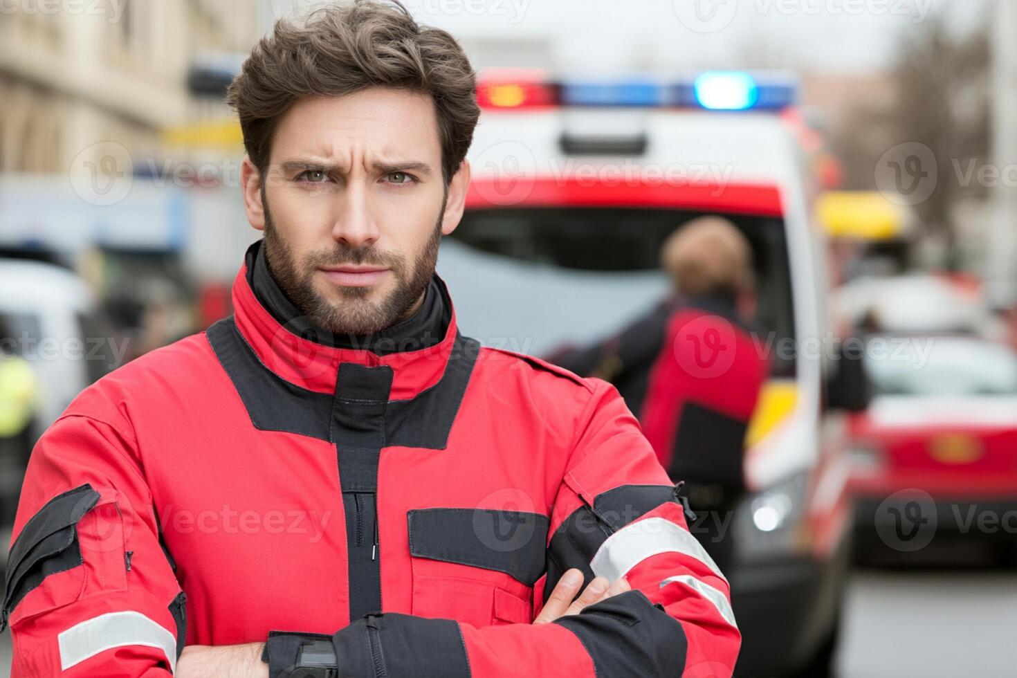 A man in a red uniform standing in front of an ambulance photo
