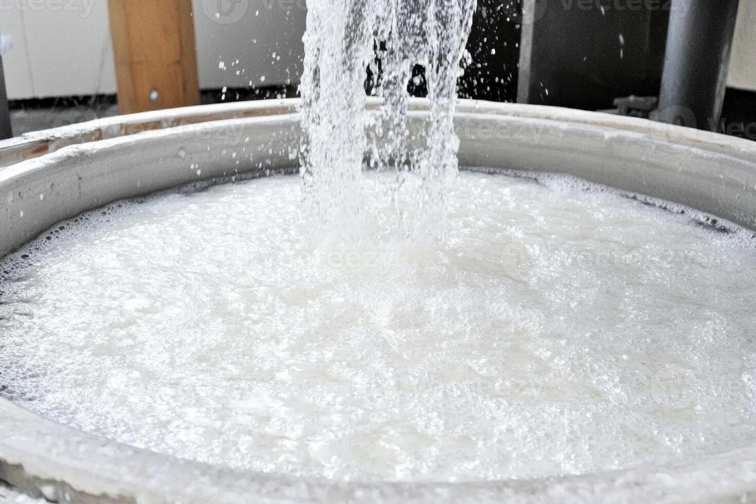 A large bowl filled with water and water coming out of it photo
