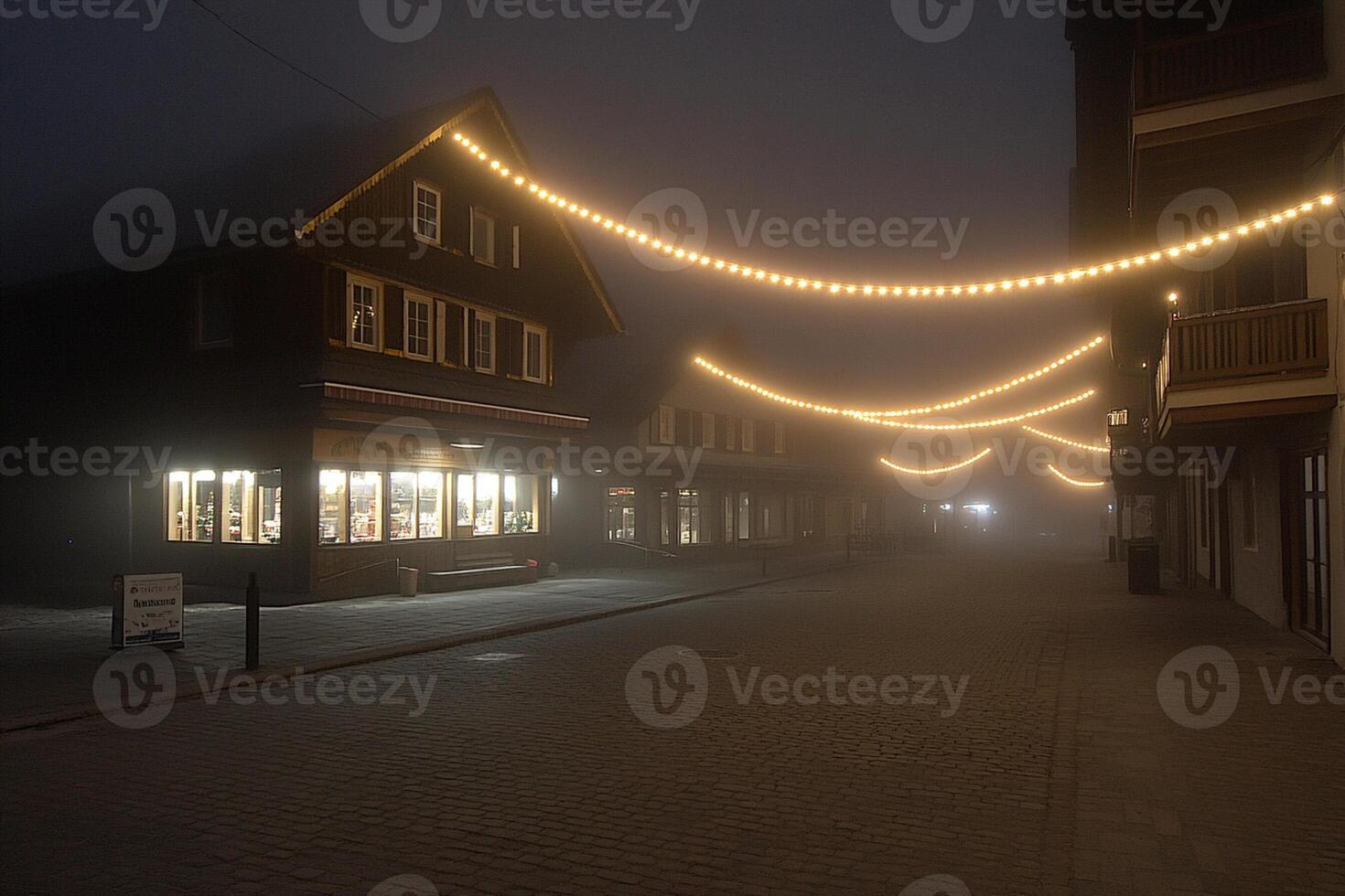 A street with a lighted store front and a street light photo