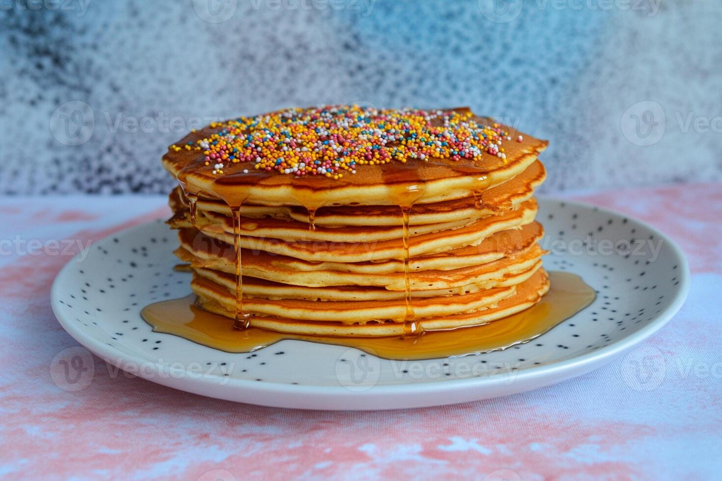 A stack of pancakes with sprinkles on top photo