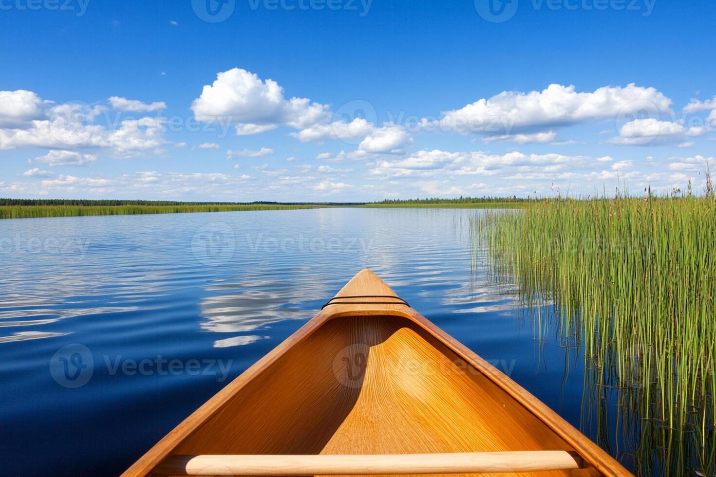 A canoe is on the water with a blue sky photo