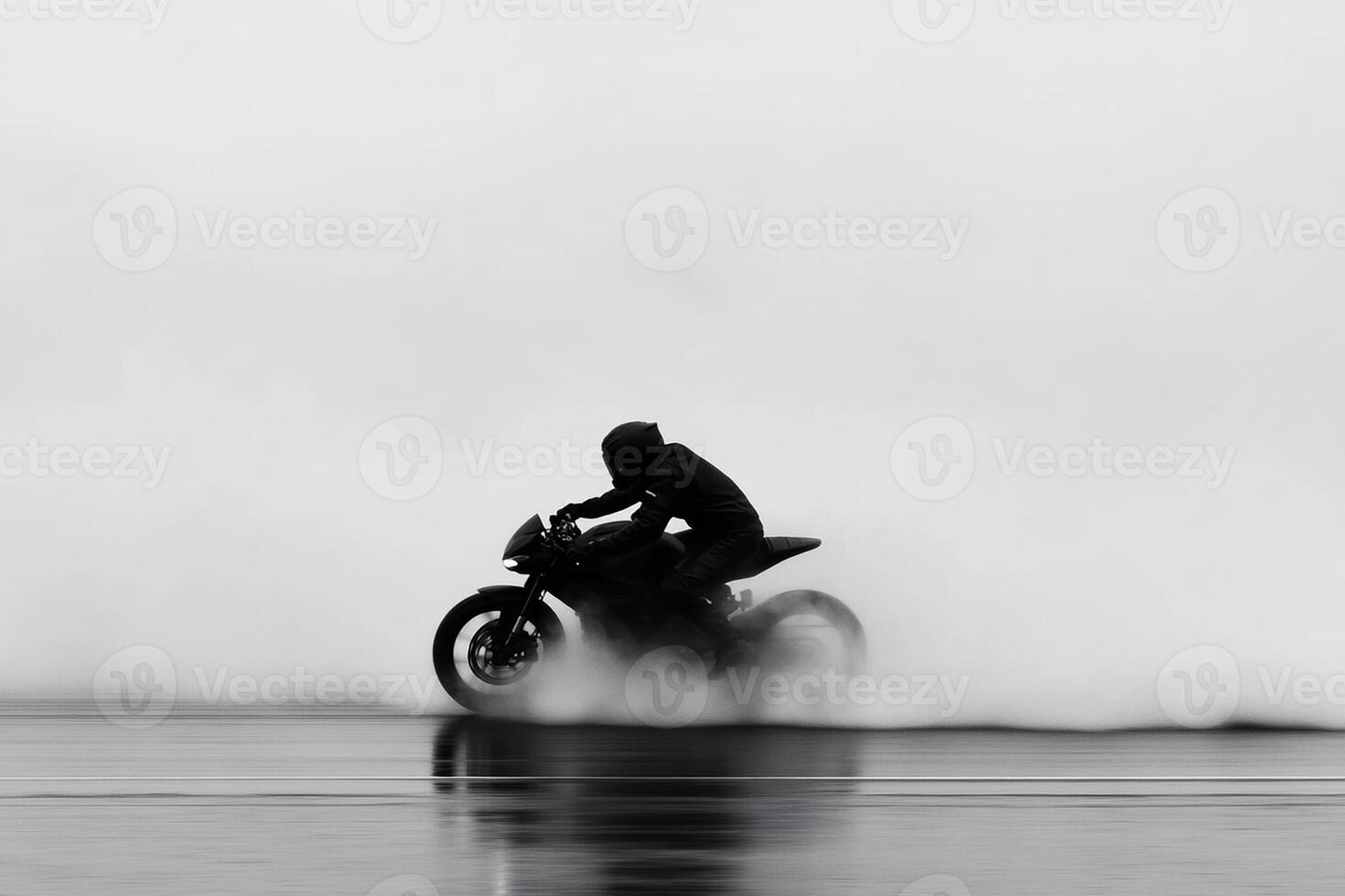 A person riding a motorcycle on a foggy day photo