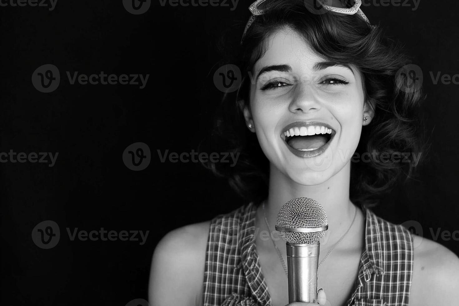A woman is singing into a microphone photo