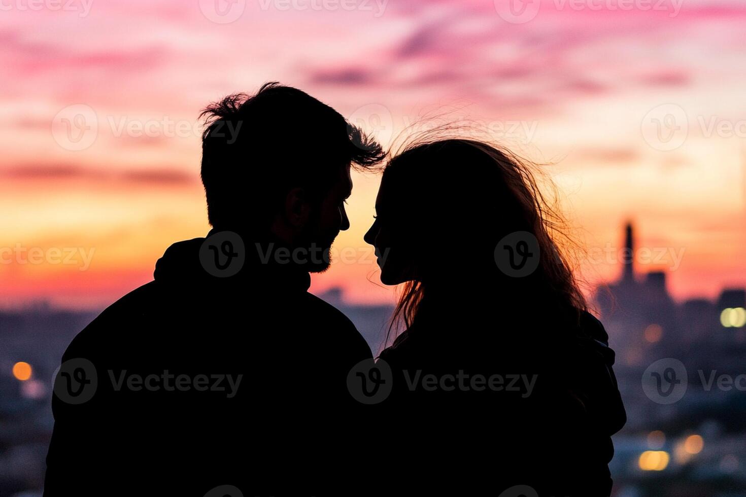 A silhouette of a couple looking at each other photo