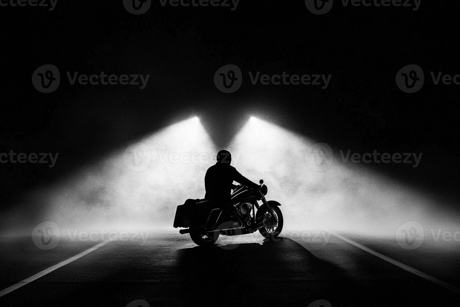 A man riding a motorcycle in the dark photo
