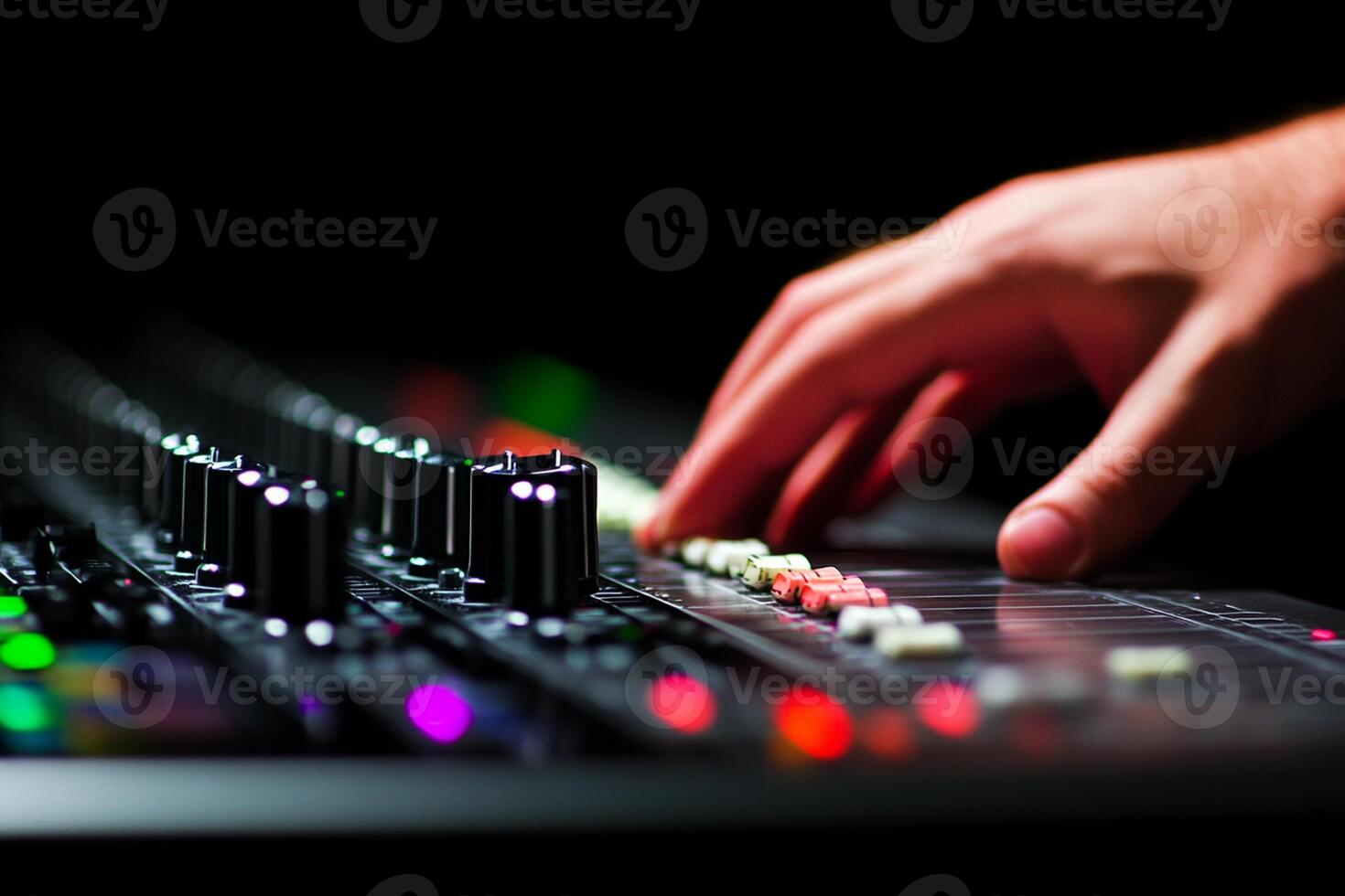 A person is playing a sound mixer on a stage photo